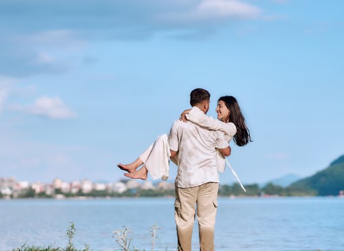 Newlywed couple enjoying a view of the Himalayan mountains during their Nepal honeymoon tour.